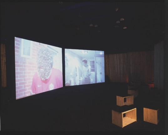 Installation view from "Home," 2003. Dual screen DVD shot with digital camera, 32 minutes. Edition of 5. MP V-7