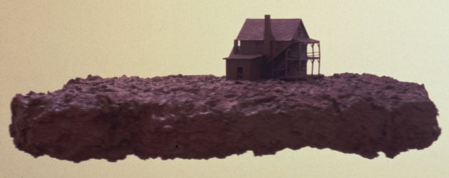 Untitled (house), 1988. Styrofoam, wood, paper mache, modeling paste, acrylic, plastic model, 9 x 25 x 22 inches. MP 163