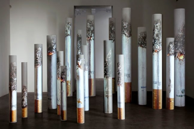 Marlboro, Camel, Winston, Parliament, Salem, Marlboro Light, American Spirit, 2009. PVC tubes, video projection, dimensions variable (largest: 83 inches high; smallest: 50 inches high. MP 587