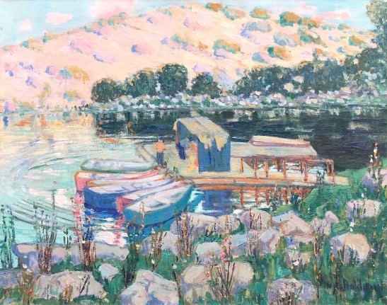 Anni Baldaugh's oil painting of pinkish-yellow southern California foothills in the distance with a lake, dock and 4 brightly colored rowboats in the foreground.