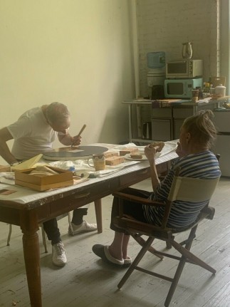 Mary Obering overseeing review and touch up of her 1983 painting Tondo.