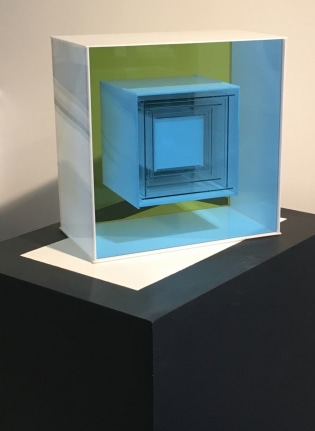 Image of a white, blue and yellow plexiglass constructed boxes within boxes entitled &quot;#128&quot; by Leroy Lamis.