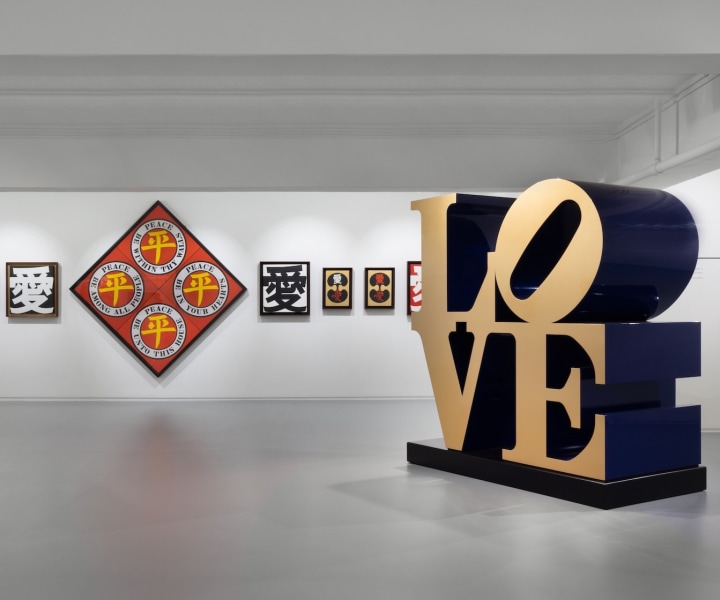 Installation image of Robert Indiana show at Ben Brown with a blue and gold LOVE sculpture and paintings from Indiana's Ai and Ping paintings