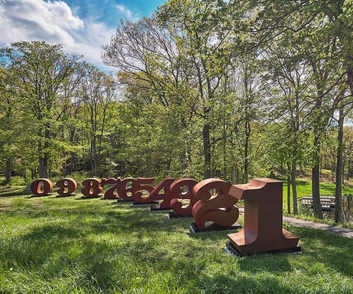 Installation view of Indiana's 72-inch-high, Cor-Ten steel sculpture ONE Through ZERO (The Ten Numbers) at Glass House