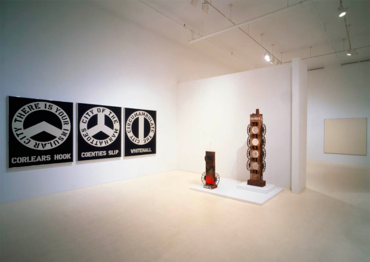 Installation view of Indiana, Kelly, Martin, Rosenquist, Youngerman at Coenties Slip at Pace Gallery, New York featuring Indiana's painting The Melville Triptych and his sculptures Soul and Moon
