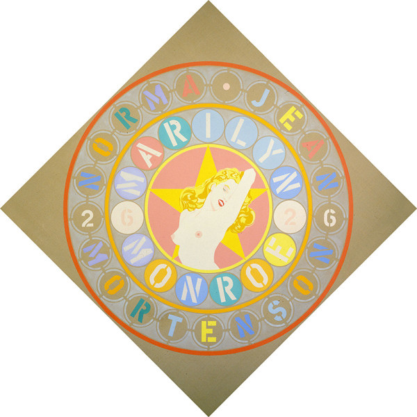 The Metamorphosis of Norma Jean Mortenson, a beige diamond shaped canvas. In the center of the painting is a topless image of Monroe in front of a yellow star in a rose colored circle. Two rings of text surround this central image. The inner ring contains the actress' name, Marilyn Monroe, and the year "62." The outer ring contains the actress' birth name, Norma Jean Mortenson, and the year "26." Each letter and number in both rings is in a circle of a different color.