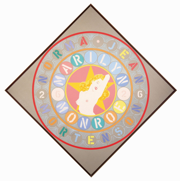 The Metamorphosis of Norma Jean Mortenson, a beige diamond shaped painting. In the center is a topless image of Monroe in front of a yellow star in a rose colored circle. Two rings of text surround this central image. The inner ring contains the actress' name, Marilyn Monroe, and the year "62." The outer ring contains the actress' birth name, Norma Jean Mortenson, and the year "26." Each letter and number in both rings is in a circle of a different color.