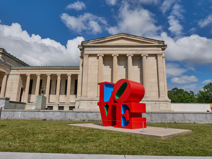 Robert Indiana's red, blue, and green LOVE sculpture installed in front of the Albright Knox for the exhibition Robert Indiana: A Sculpture Retrospective