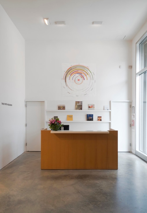 installation view of the gallery's reception area, which has a an artwork right above it