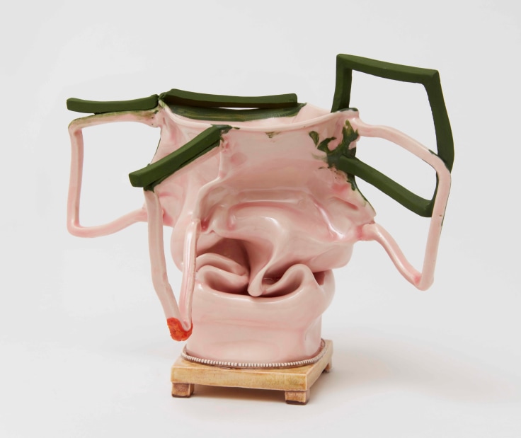 Caved-in pink and green clay sculpture with big handles by Kathy Butterly.