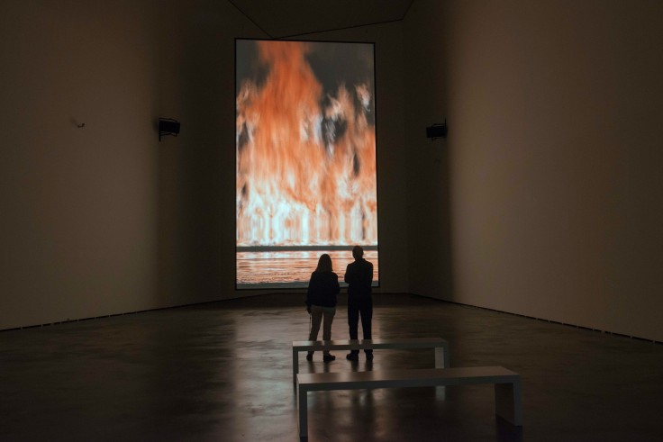 Installation view of a video of a raging fire