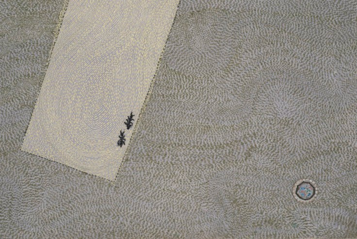 close up of white rectangle with two ants inside, and a small circle next to it