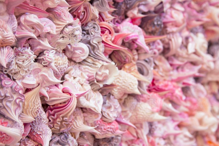 dollops of pink, purple, and white whipped cream substances packed together