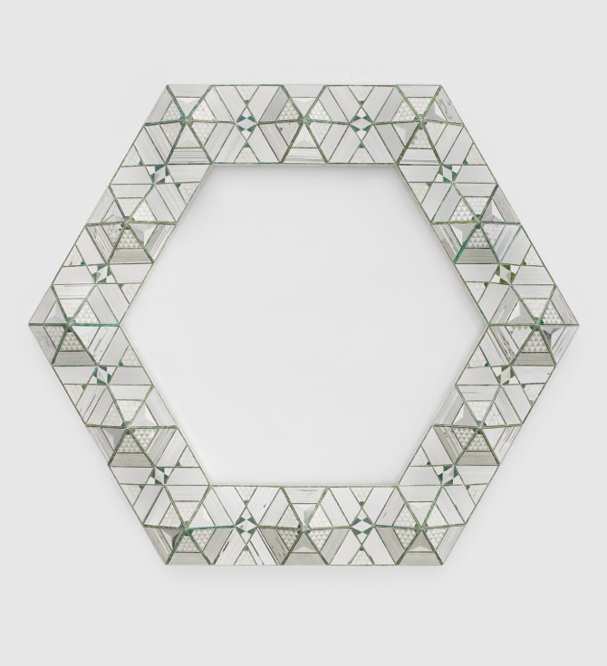 Geometric reverse glass sculpture mounted to the wall with painted details by Monir Shahroudy Farmanfarmaian.