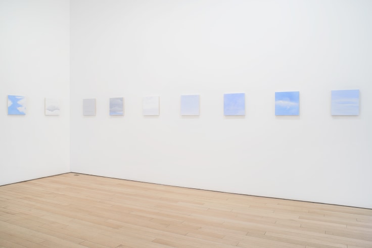 installation view of several square canvases in a row