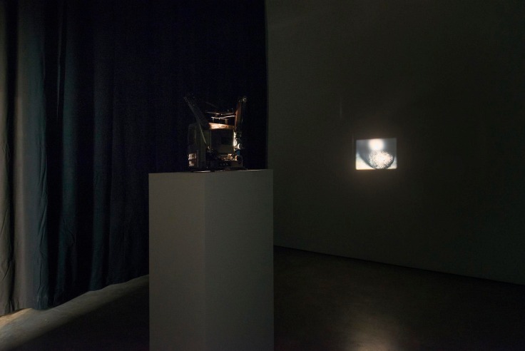 installation view of a projector in a dark room