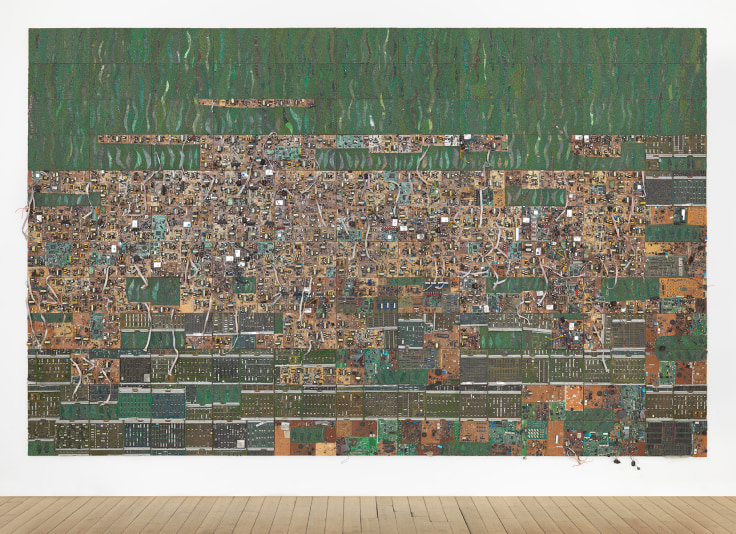 reclaimed electrical wires and components organized on a panel creating a mostly green surface with browning in the middle