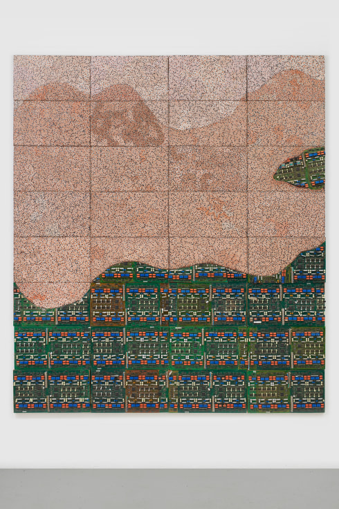 green and light orange shapes on a panel composed of electrical components