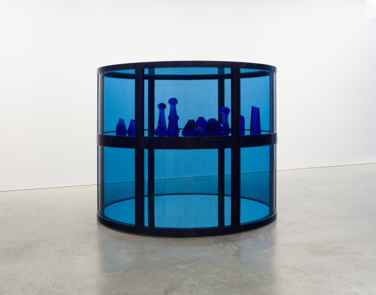 Cylindrical blue glass structure with blue glass sculptures inside