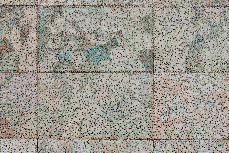 close up of woven electrical wires creating a swirling and dotted surface