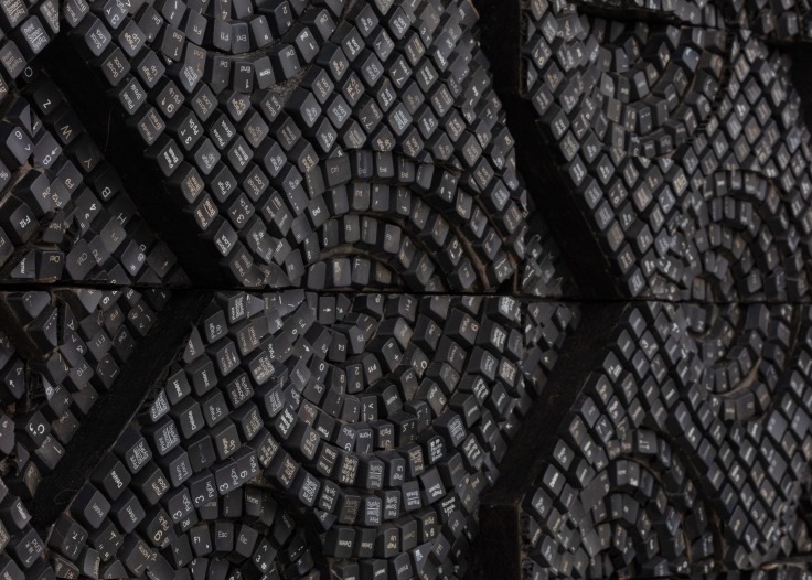 detail of panel containing keyboard keys forming various geometric shapes