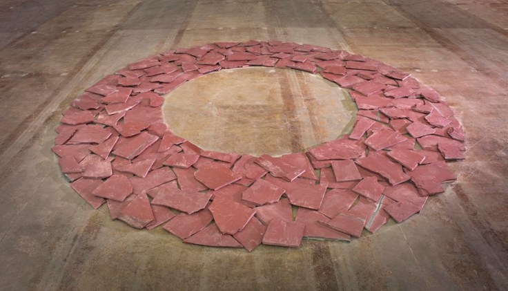Jagged red slate stones arranged in a circle without a center.