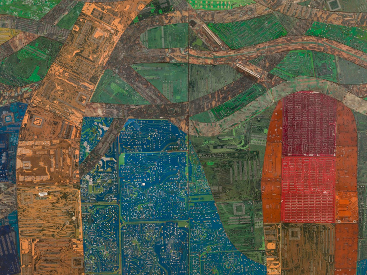 close up of reclaimed electrical panels creating blue, green, red, and light orange colors