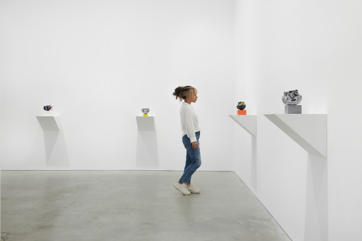 person viewing one of four artworks