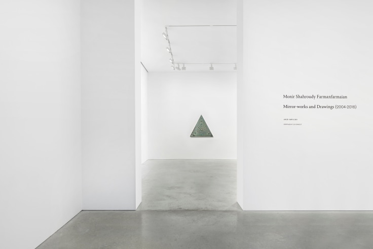 exhibition entrance with a view of a triangle made of glass