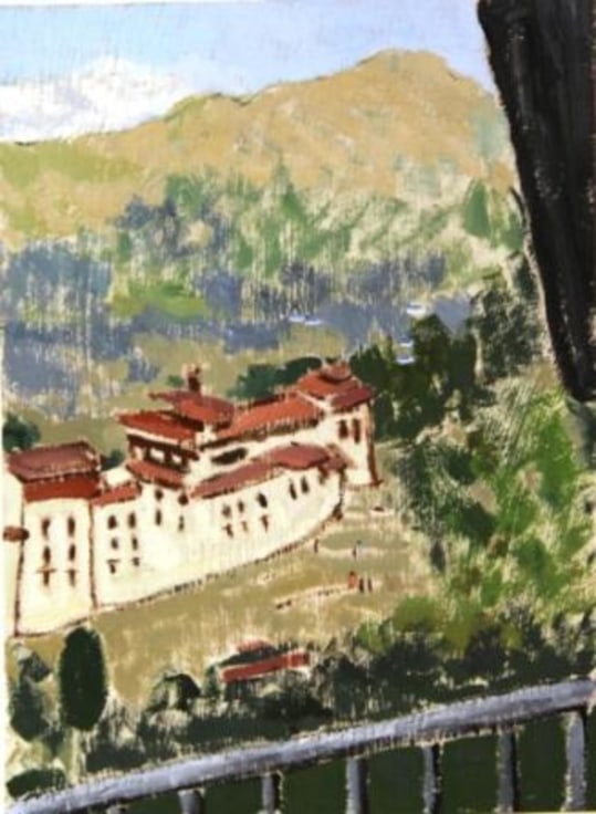 distant view of the town of Trongsa composed of various eggshell-colored buildings