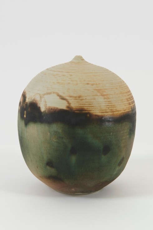 round closed ceramic form covered in an earth tone glaze