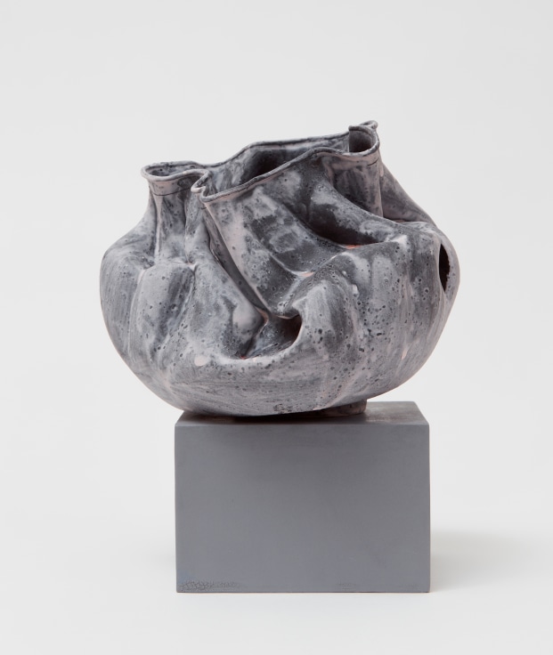 Porcelain bowl that is folded-in with an opening on the side by Kathy Butterly.