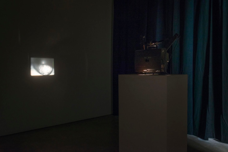 installation view of a projector in a dark room