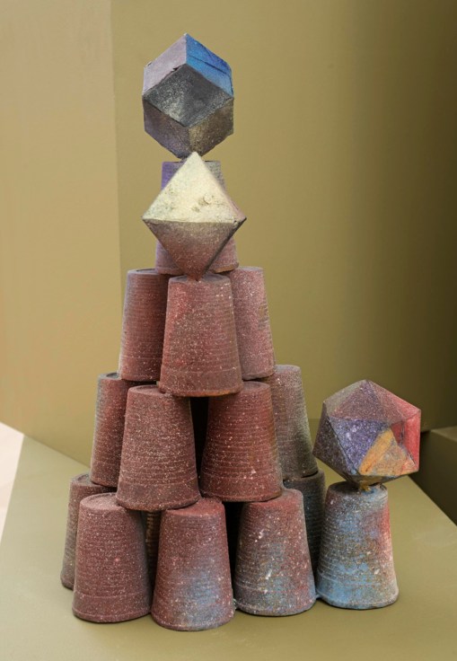 cups and geometric shapes balancing on each other