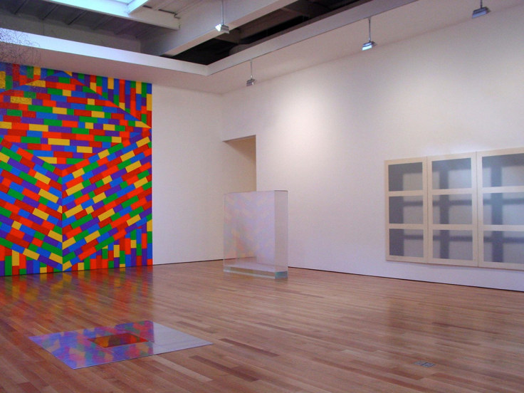 installation view of varying square and rectangular artworks