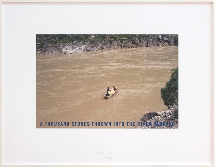 Unique color photograph with blue lettering stating &quot;a thousand stones thrown into the river yangtze&quot;