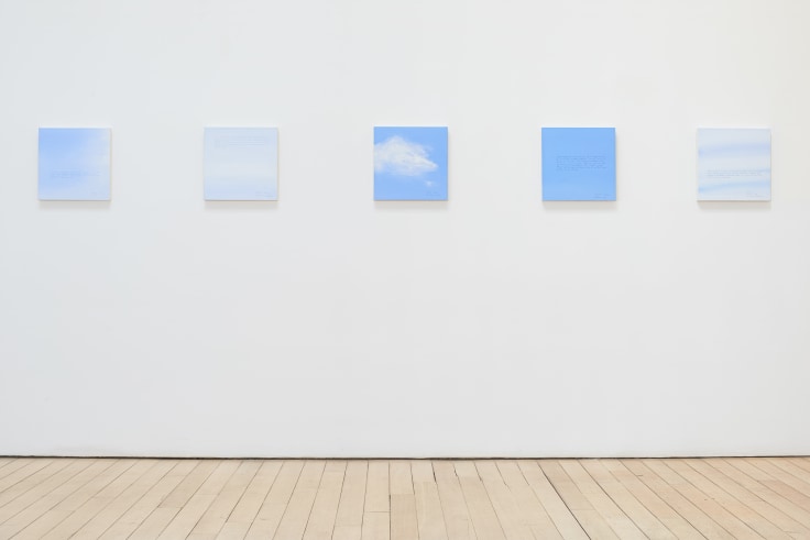 installation view of several square canvases in a row