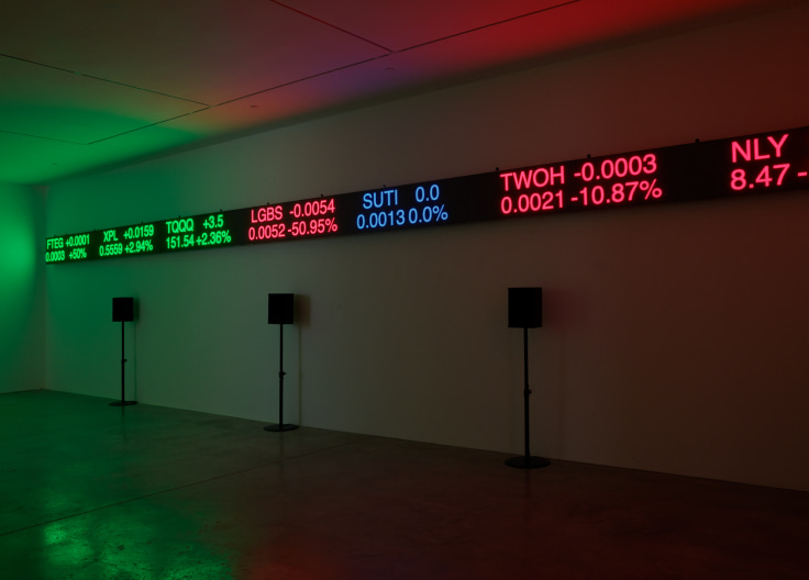 display showing stock information along with speakers below it