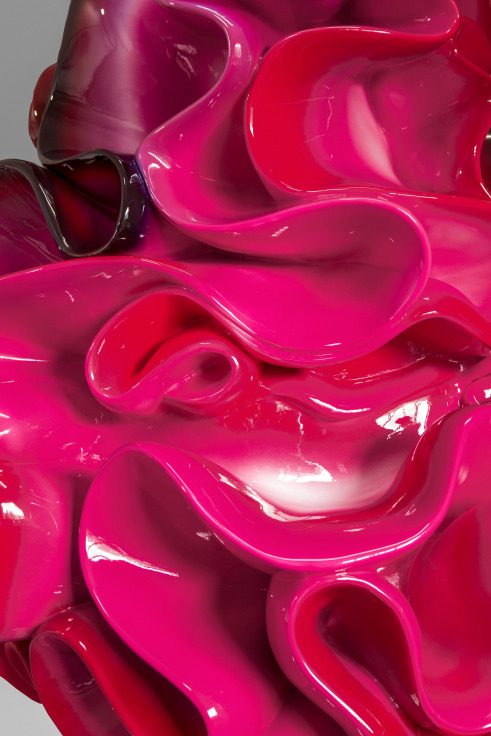 Zoomed in detail of a sculpture of fluorescent pink dollop of whipped cream