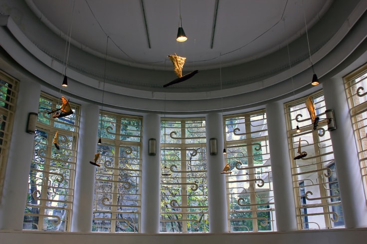 installation view of artworks hanging from the ceiling