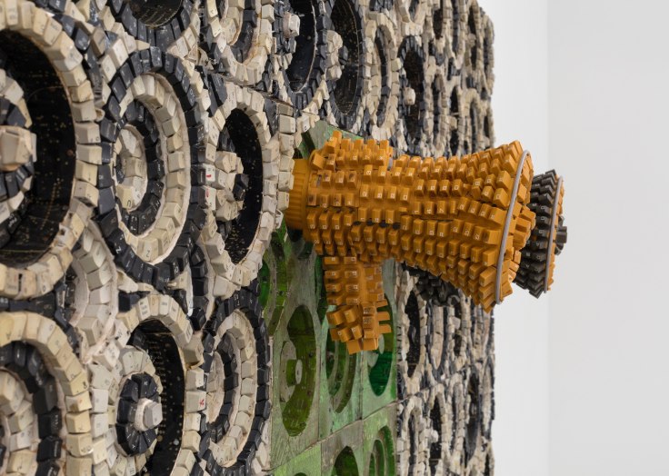 megaphone covered in keyboard keys emerging from a surface also covered in keyboard keys