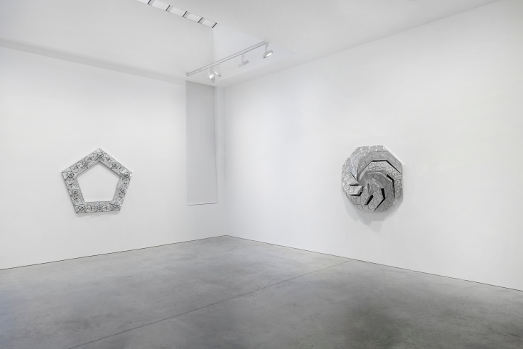 view of two geometric, glass artworks