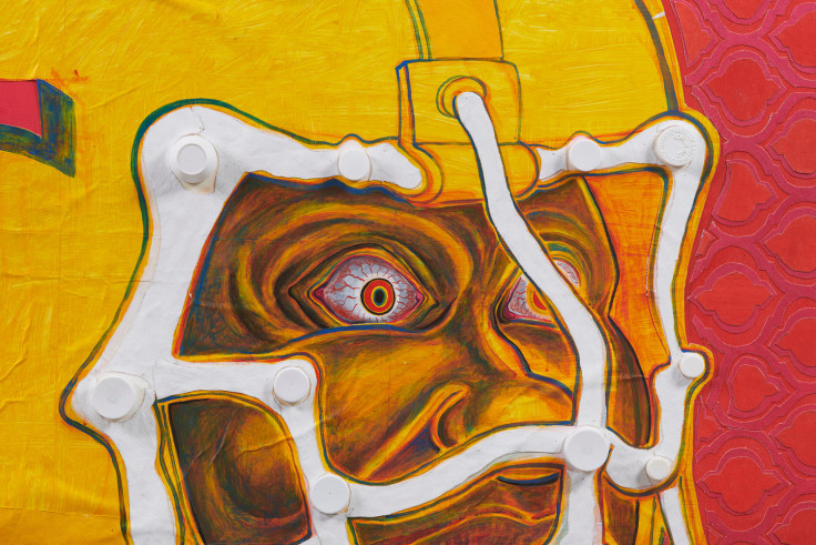 close up of a man's face wearing a yellow football helmet