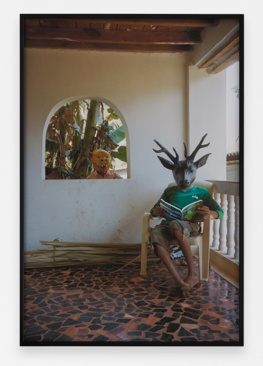 Archival pigment print featuring two people in animal masks
