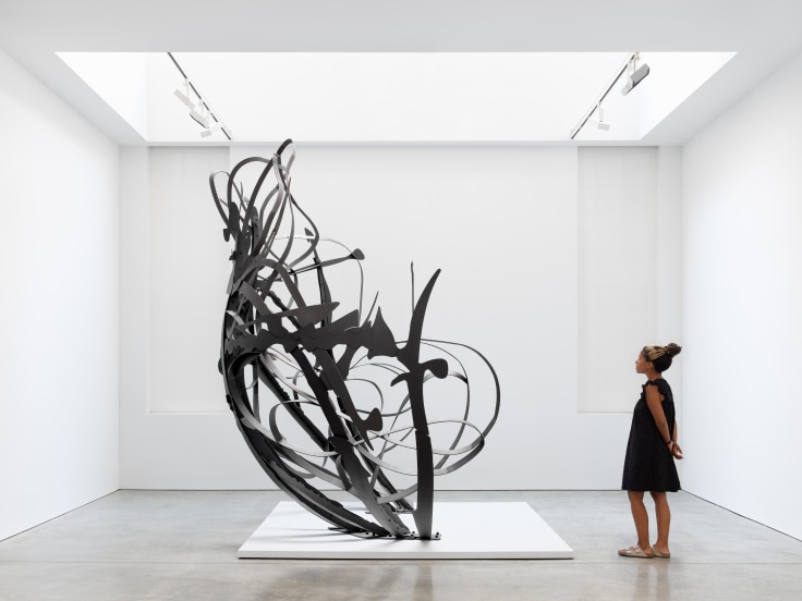 Large scale steel sculpture with arms of implied motion
