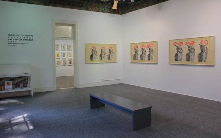 Installation view of exhibition entrance with three artworks and wall vinyl
