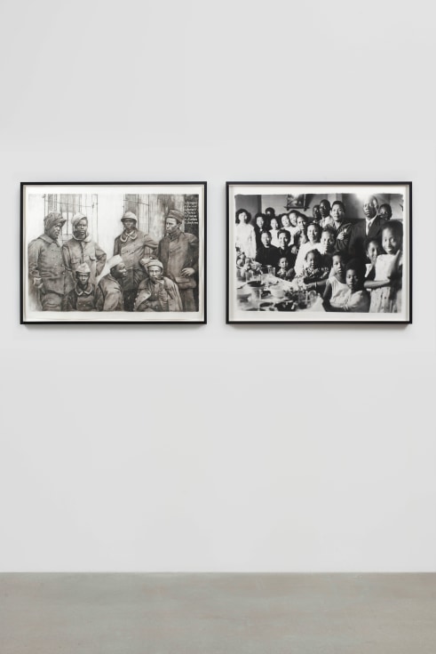 two black and white photographs hanged side by side; the image on the left depicts a group of soldiers while the other shows a large and happy family