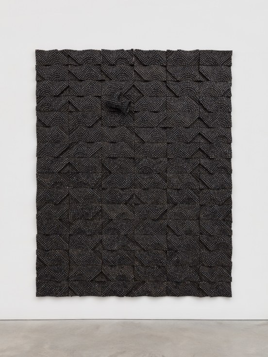 one megaphone composed of electrical components emerging from a pane which also contains electrical components, all in black