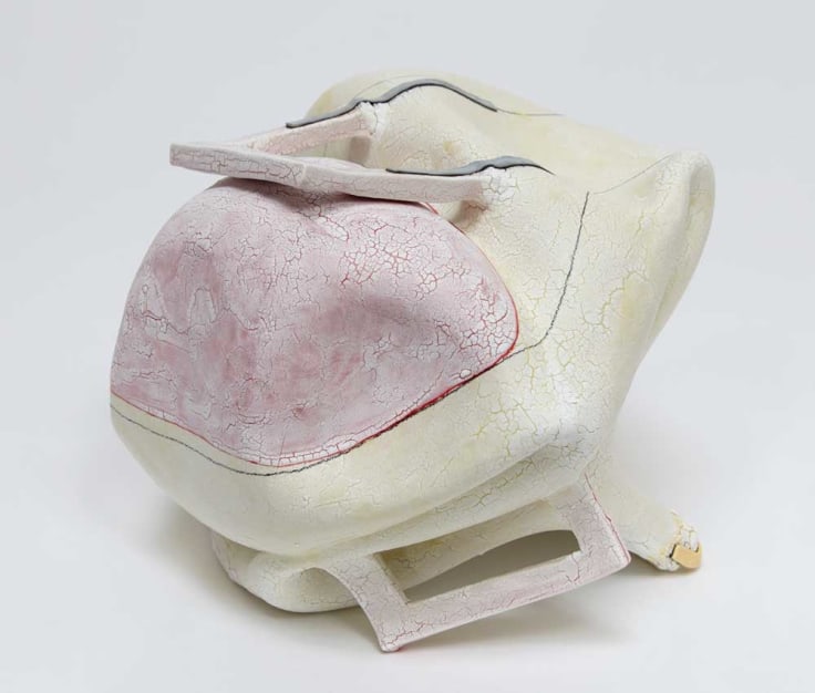 Organically-shaped clay sculpture with geometric handles by Kathy Butterly.
