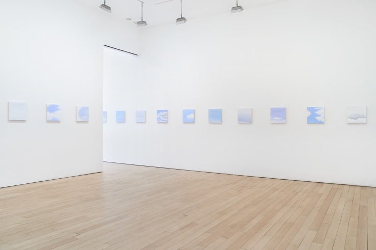 installation view of several square canvases in a row